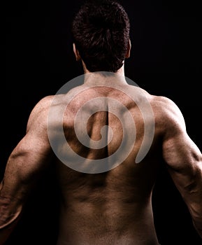 Back muscles of big healthy naked man