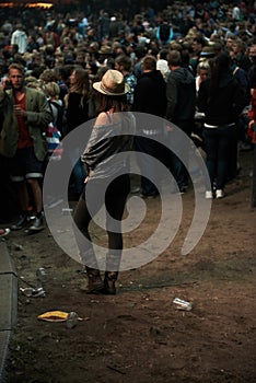 Back, music festival and a woman in the crowd of a concert at night for an event, show or performance. Party, carnival