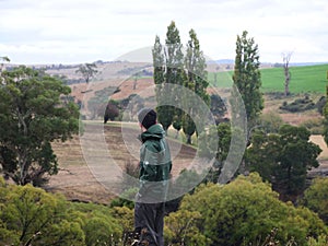 The back of an outdoorsman with a magnificent view in the background photo