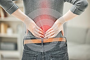 Back, pain and backache of a woman touching and holding a painful area on her body highlighted in red. Closeup of a