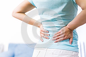 Back pain at home. women suffer from backache. healthcare and medical concept