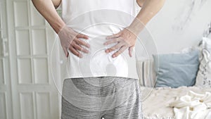 Back pain, kidney inflammation, man suffering from backache at home