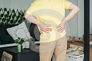 Back pain, kidney inflammation, man suffering from backache at home