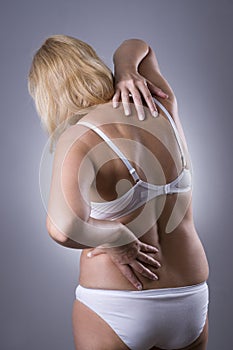 Back pain, massage of female body, ache in woman`s body