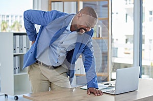 Back pain, spine and injury with businessman at desk for burnout, muscle and fatigue. Overworked, stress and accident