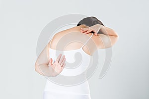 Back pain, woman with backache on gray background