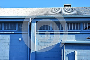 Back of pale blue industrial building
