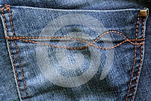 Back pocket of blue jeans detail