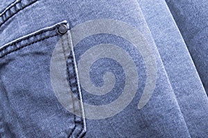 back pocket of denim trousers. with ripped denim jeans close up for pregnant women