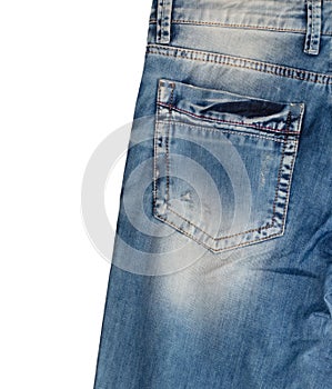Back pocket and waist area of light blue jeans with faded white spots, isolated on white background. Close up shot. Copy space.
