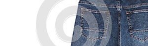 Back pockets and waist area of dark blue jeans isolated on white background. Close up shot. Copy space. Banner size. Clothing