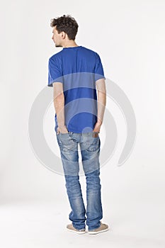 Back portrait of a young man in blue, studio shot