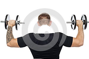 Back pose of male bodybuilder lifting weights