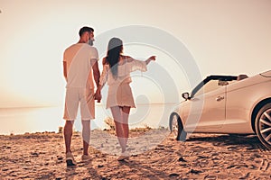 Back rear view full body photo of young couple seaside journey car transport point indicate finger date romantic summer