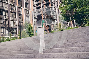 Back rear view photo of gorgeous woman walking city center spending weekend time outside