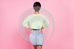 Back rear view photo of young girl spine hands in pocket incognito anonym isolated over pink color background