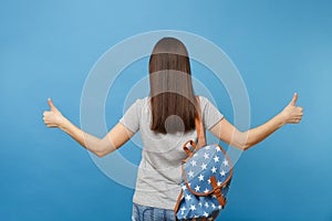 Back rear view of young brunette woman student in casual clothes with backpack standing showing thumbs up isolated on