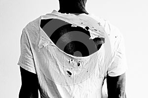 Back of a man wearing a ripped white t-shirt photo