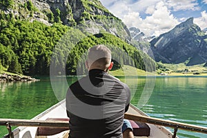 back of rower in front beautiful Seealpsee lake and Alpstein mountain in Appenzell, Switzerland