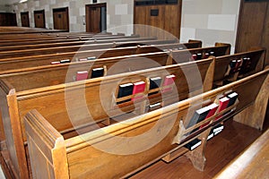 Back of rows of church pews with Bibles