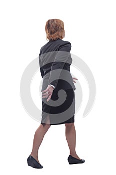 The back of semior businesswoman walking away