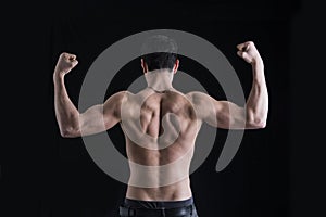 Back of shirtless muscular young man doing double