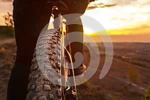 Back shot of mountain bike rear wheel. Bicycle wheels close up image on sunset.