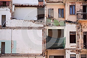 Back side of an abandoned brick apartment building in Manhattan, revealing urban decay, the fire escape and graffiti on