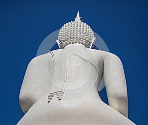 Back side the big white buddha on blue sky background