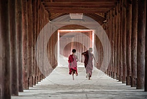 Back side of Buddhist novice are walking in temple