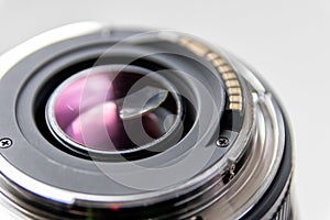 Back side of a dslr camera lens objective for professional photography with camera mount details in macro view with beautiful lens