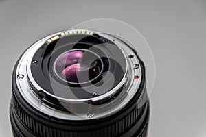 Back side of a dslr camera lens objective for professional photography with camera mount details in macro view with beautiful lens