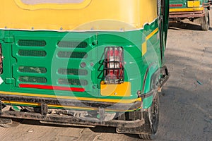 The back side of traditional motorized rickshaw or tuk tuk taxi on the street.