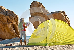 Back side of traveler girl searching right direction on map,