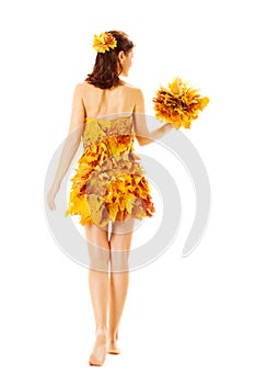 Back side view of Autumn woman in dress of maple leaves