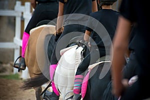 Back side view of a group of riders