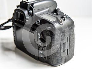Back and side view of professional DSLR photo camera on white background