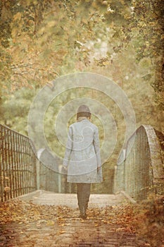 Back side view at Young redhead woman in blue coat