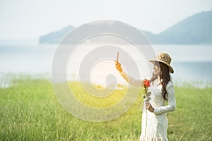 Back side woman feeling fresh freedom positive energy standing grass field flower meadow international woman`s day 8 march.