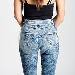 Back side of woman wearing high-waisted jeans photo
