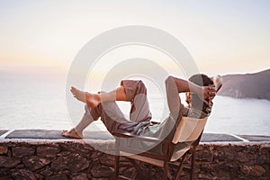 Back side of young man looking at the sea, vacations lifestyle concept