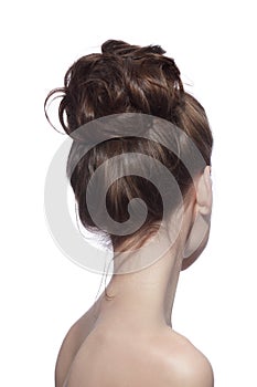 Back of slim woman with fancy prom hair bun