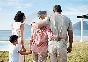 Back, summer and vacation by the sea with family outdoor together looking at a view of nature. Grandparents, mother and