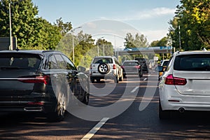 Back tail view of many cars stuck in row at highway city street road traffic jam. Automobile accident vehicle rush hour