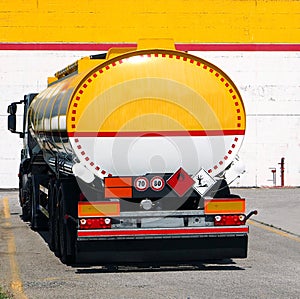 Back of a tank truck in front of a building