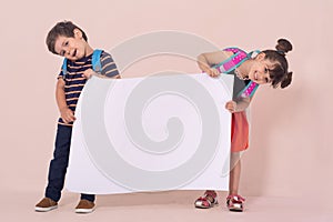 Back to school - advertisements. School Kids with backpacks holding white blank or white card.