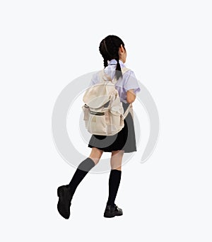 Back to school. Asian junior school student in british international uniform carrying backpack walking