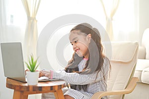 Back to School. asian Little girl using his laptop