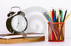 Back to school background with books and alarm clock