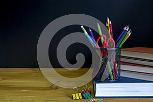 Back to school background with books over blackboard